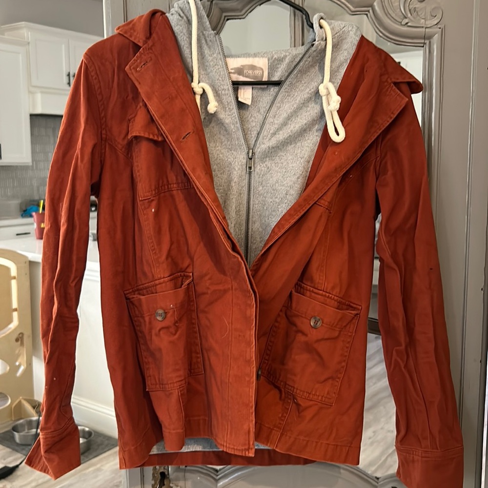 Rust color jacket with gray hoodie